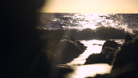 slow motion slider shot of ocean waves crashing on rocks