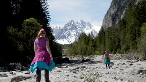two women hiking through stone valley next to river in german alps near berchtesgaden wimmbachklamm