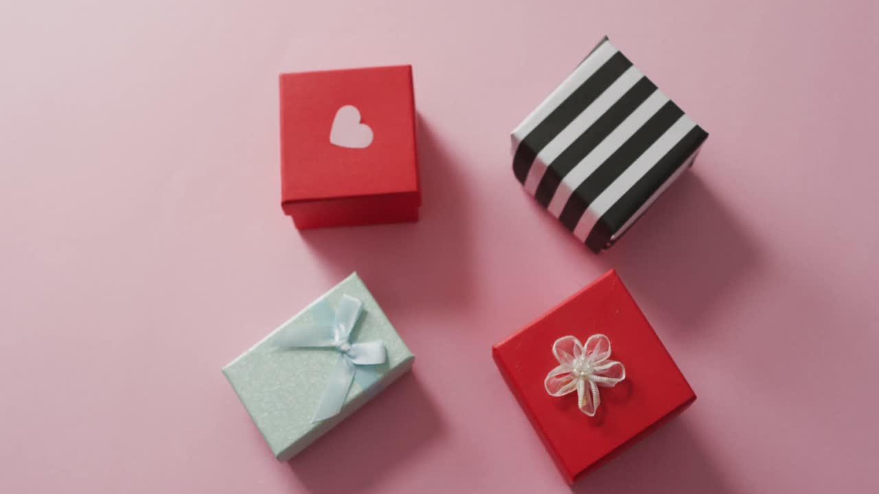 Gifts with heart on pink background at valentine's day