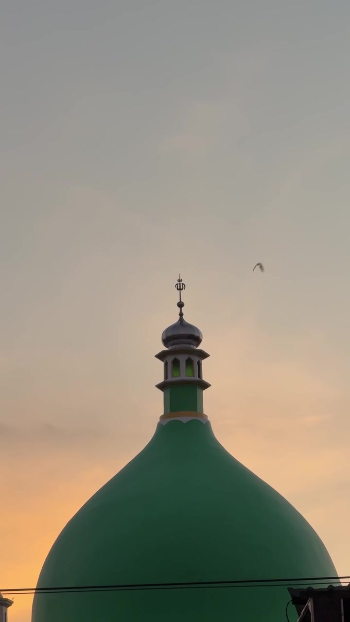 Green Mosque Dome Against a Sunset Sky