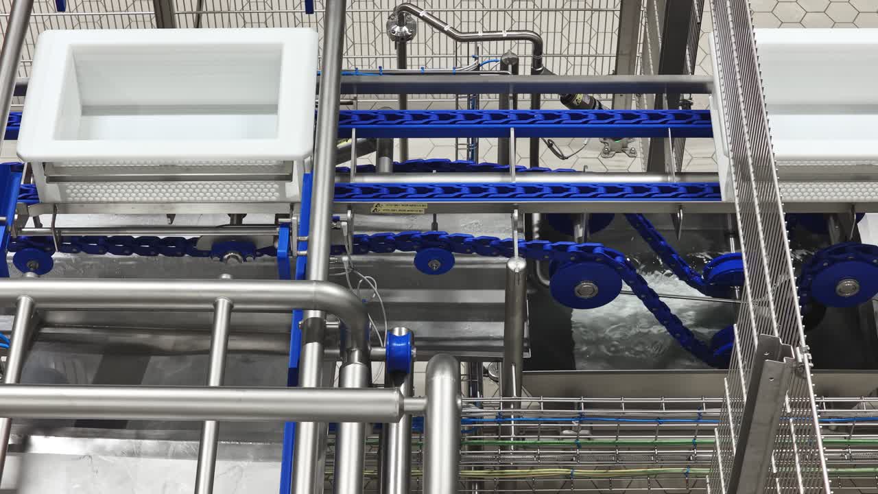 Modern factory machinery with conveyor, metal parts in motion