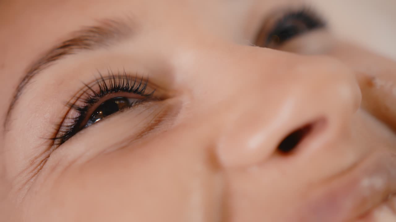 Woman getting mascara applied