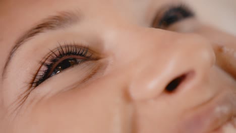 woman getting mascara applied
