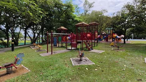 a vibrant public playground for children in a beautiful tropical park. sunny weather enhances the cheerful outdoor atmosphere