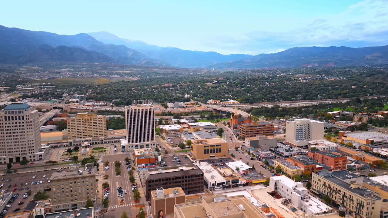 Colorado Springs, USA, 22 July 2025: Panorama of Colorado Springs, Colorado, USA from drone footage. Midtown and uptown of the city with hazy mountains at backdrop