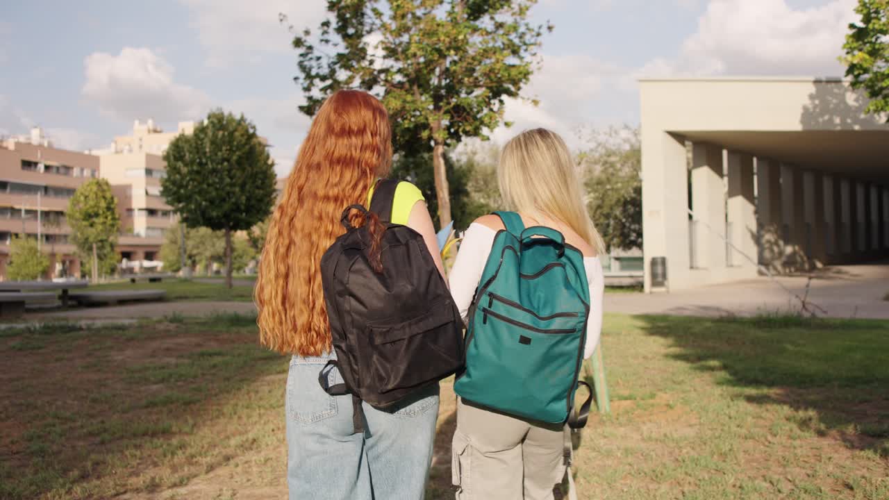 Two female students walking on campus