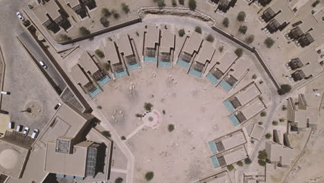 Aerial-top-down-view-of-beautiful-beresheet-hotel-on-a-crater-cliff,-Abstract-hotel-view-with-rooms-and-pool-1