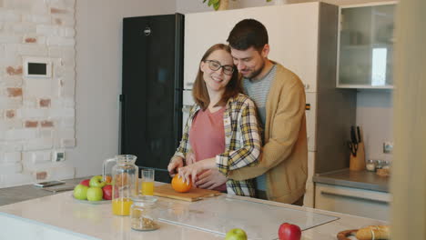 pregnant couple enjoying breakfast together in kitchen