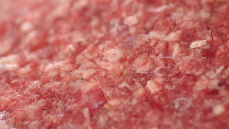raw burger meat slowly rotates. macro background.