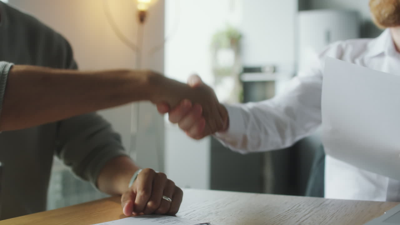 Man Signing Contract with Financial Advisor