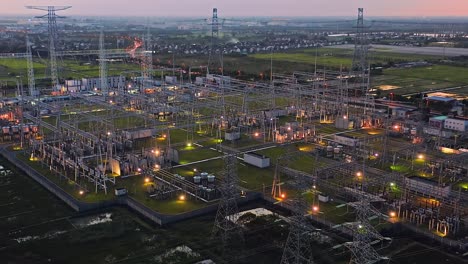 aerial footage of high voltage power tower in substation