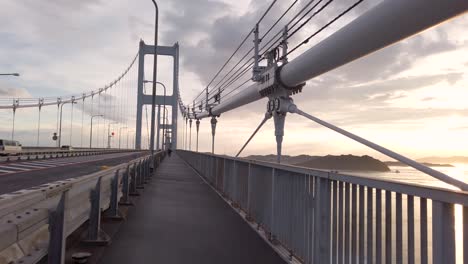 cycling point of view shot on the kurushima kaikyo at sunset, ehime japan