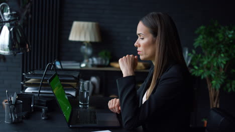 Successful-businesswoman-calling-video-online-on-laptop-with-green-screen