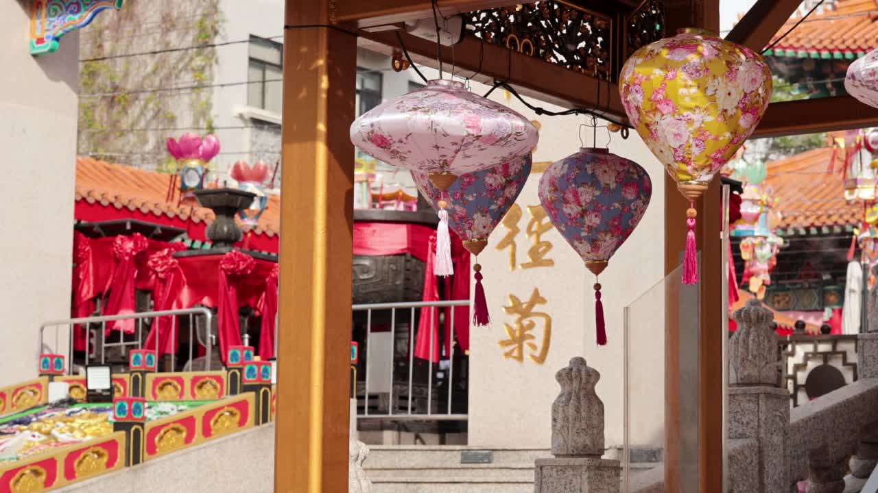 Vibrant lanterns sway at a traditional temple