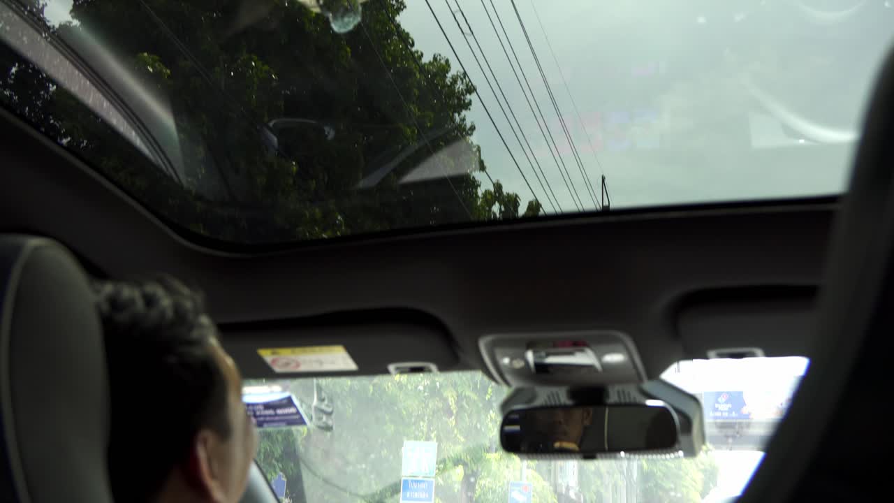 View from inside car, open sunroof protection and reveal tinted panoramic glass