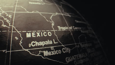close-up of a vintage world globe focusing on mexico