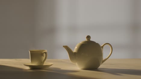 Studio Shot Of Making Traditional British Cup Of Tea Using Teapot 7