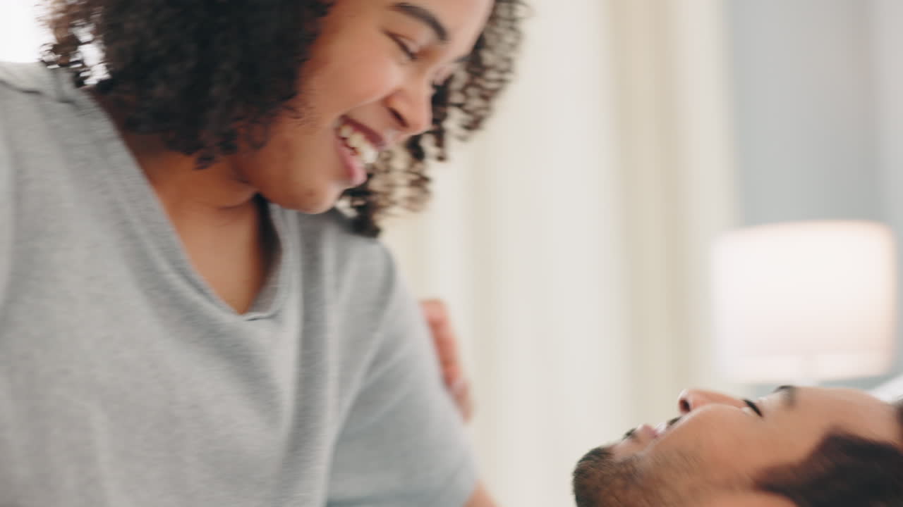 Love, funny and playful with a black couple in bed