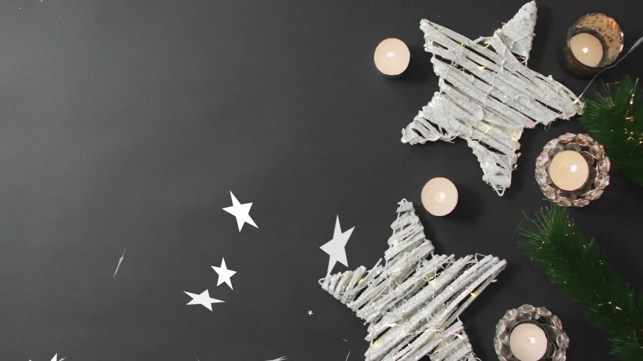 Christmas decorations with white stars and candles on dark background