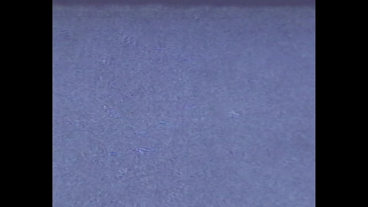 Still water over tiled pool surface in retro video frame