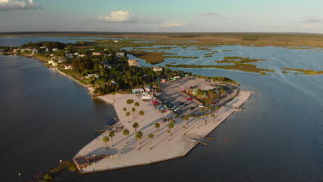 Aerial-dolly-in,-small-little-island-with-desert-beach-at-sunset