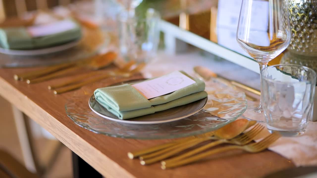 Beautifully Decorated Wooden Table with Elegant Floral Arrangements and Fine Tableware in Slow Motion