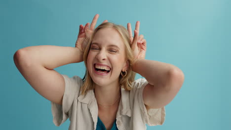 playful woman with peace sign and ear horns