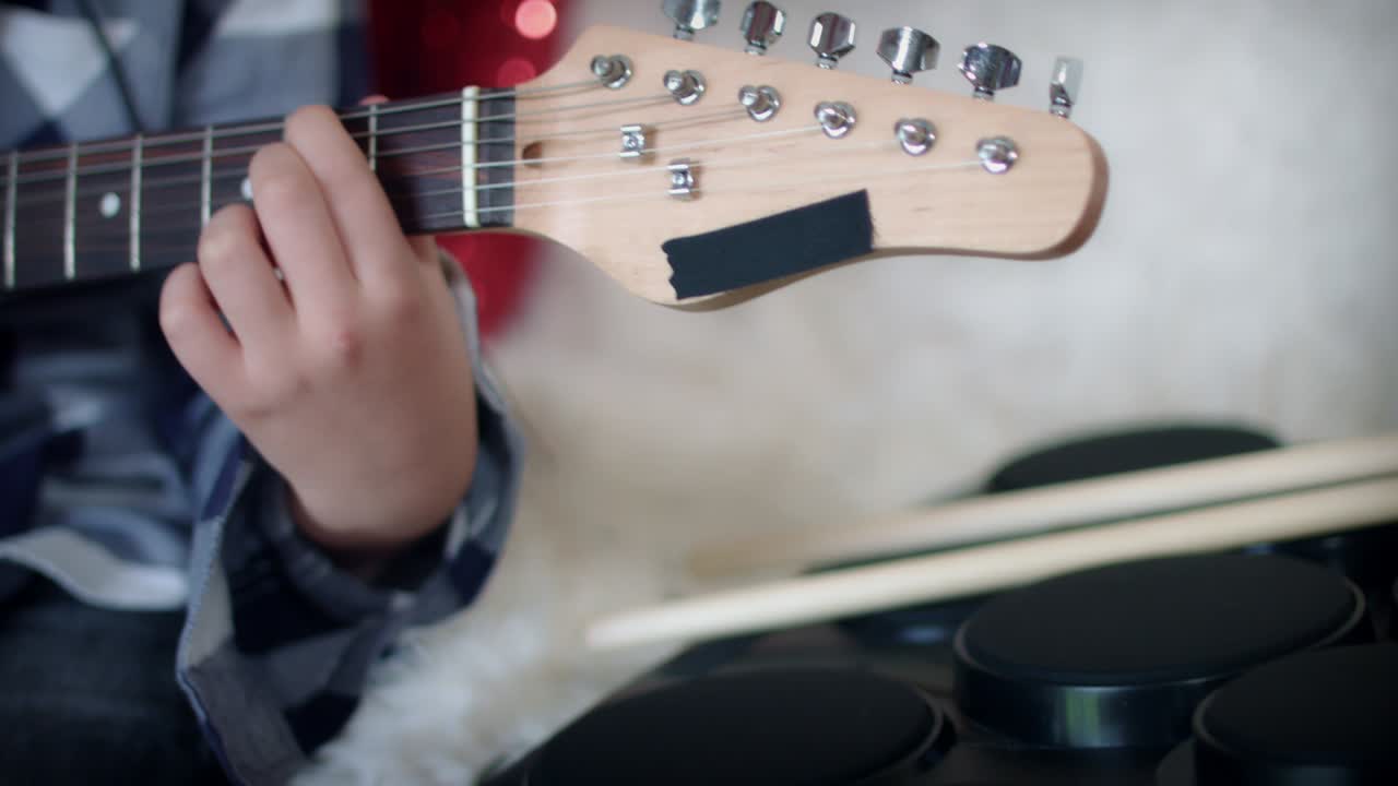 4k 가정 음악 연습, 아이가 헤드폰으로 기타를 연주합니다.