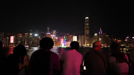 people enjoying hong kong's illuminated skyline