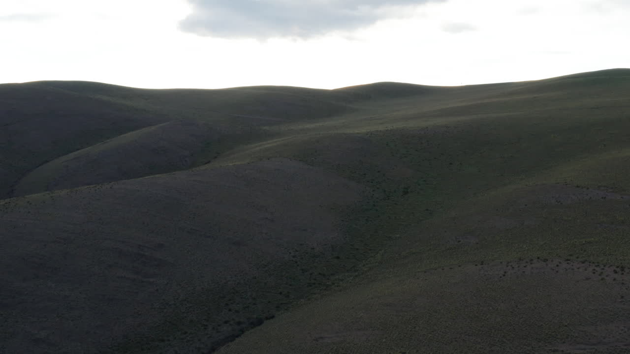 Hills around Serranias el Hornocal, Argentina, wide rising aerial shot