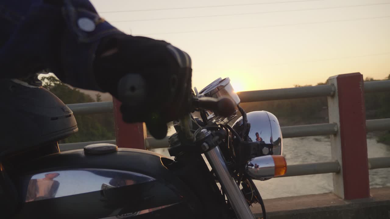 Motorcycle Rider on a Bridge at Sunset