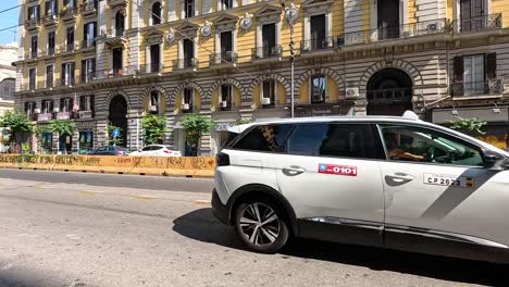 vehicles driving past a historic building