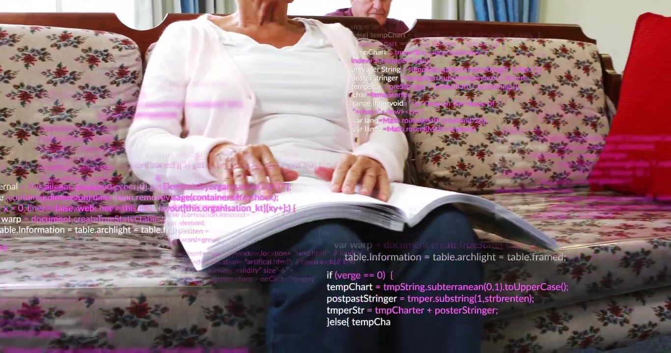 Senior woman flipping book pages causing scrolling code overlay with man nodding during tech demo