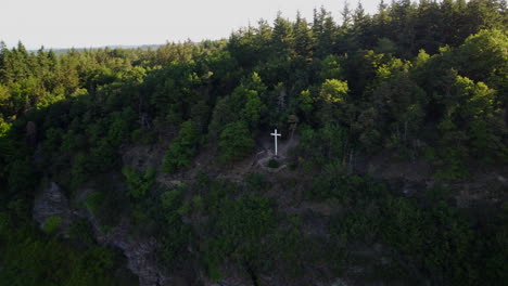 camera flies around a cross on the summit of a vineyard