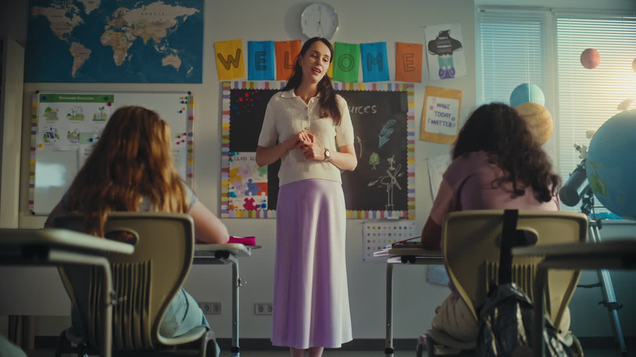 Dolly Shot of Female Teacher Starting Lesson Teaching Ecology to Primary School Children in