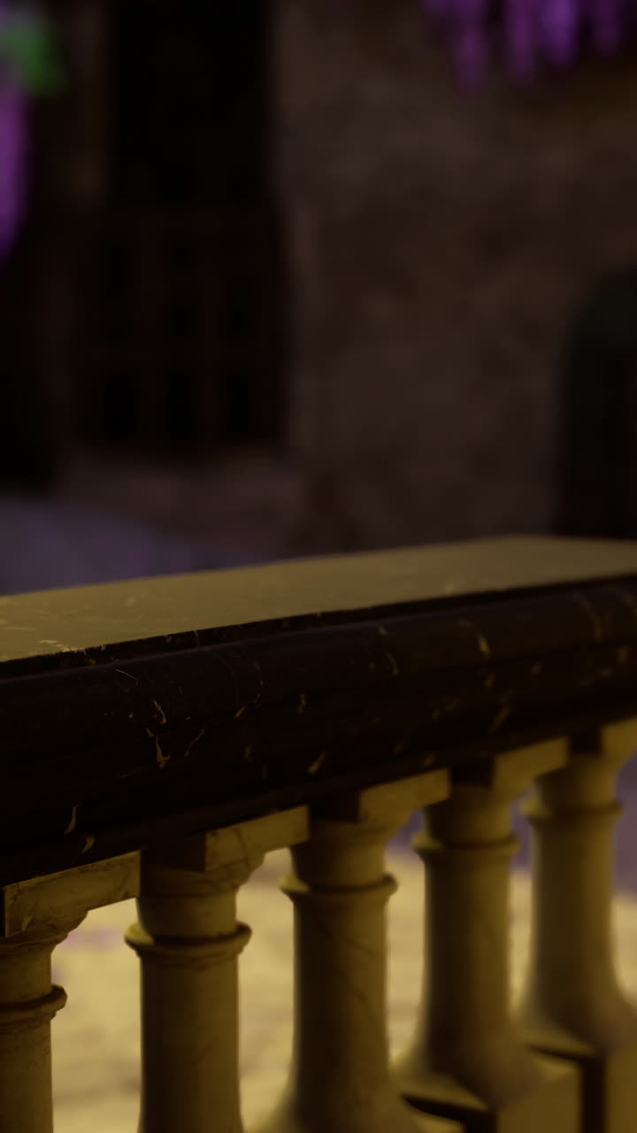 Elegant courtyard with decorative railing and hanging flowers in soft light