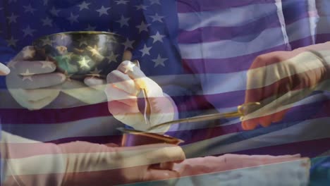 animación de la bandera de los estados unidos de américa ondeando sobre los cirujanos en el quirófano