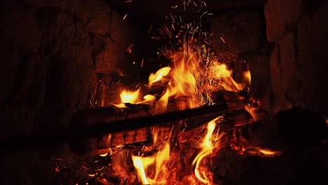 a iron poker stir and prod burning firewood in fireplace.