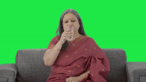 Sick-Indian-old-woman-taking-medicine-Green-screen