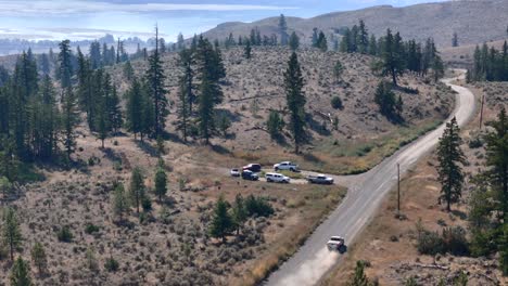 pickup truck adventure: aerial perspective of dusty desert road in forest