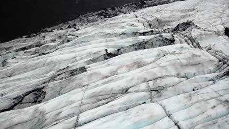 aerial view of an extreme hiker on a large ice glacier