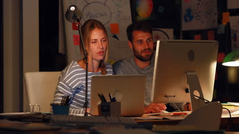 Casual-colleagues-working-with-computer-at-night