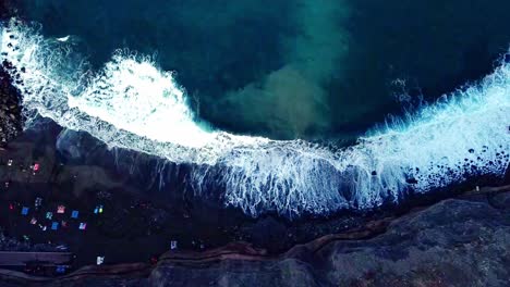 overhead shot of waves fading smoothly on rocky beach, tenerife, spain