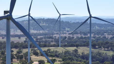 close view telephoto drone of wind turbines turning in wind in australia, 4k