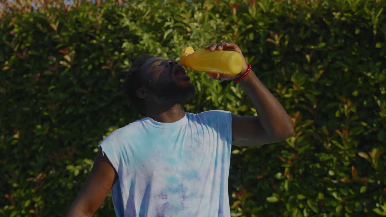 Man drinking water outdoors