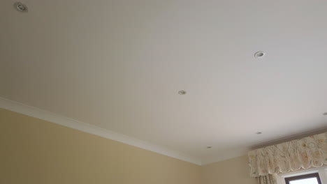 downward tilt shot of a master bedroom in a family home in slow motion