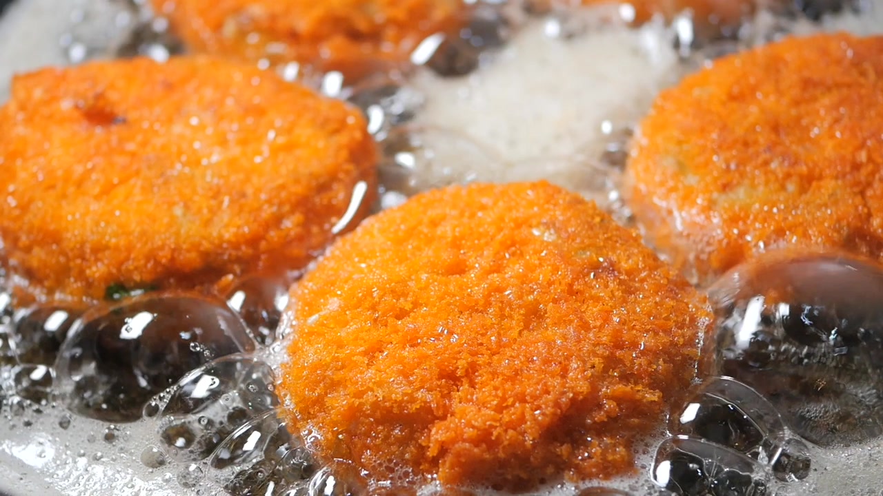 Close-up of Golden Croquettes Deep Frying in Sizzling Oil