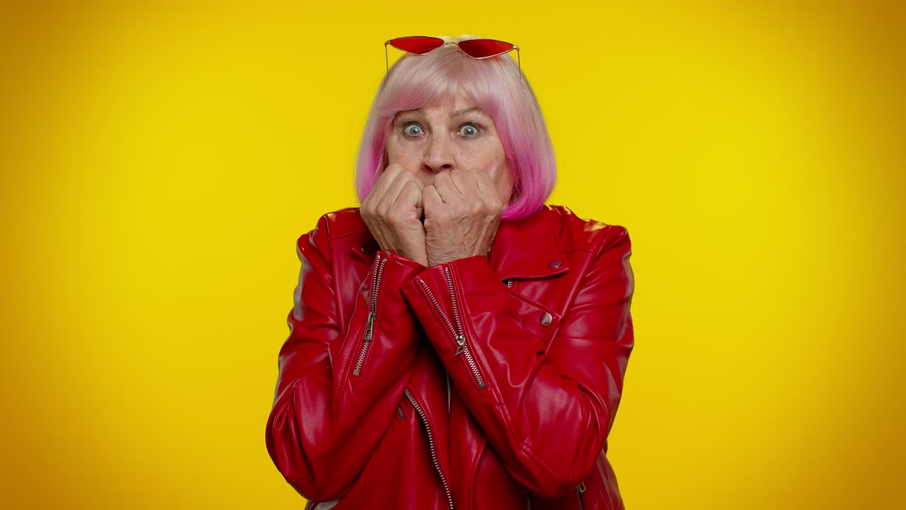 Upset scared stylish grandmother biting nails, feeling worried nervous about serious troubles stress