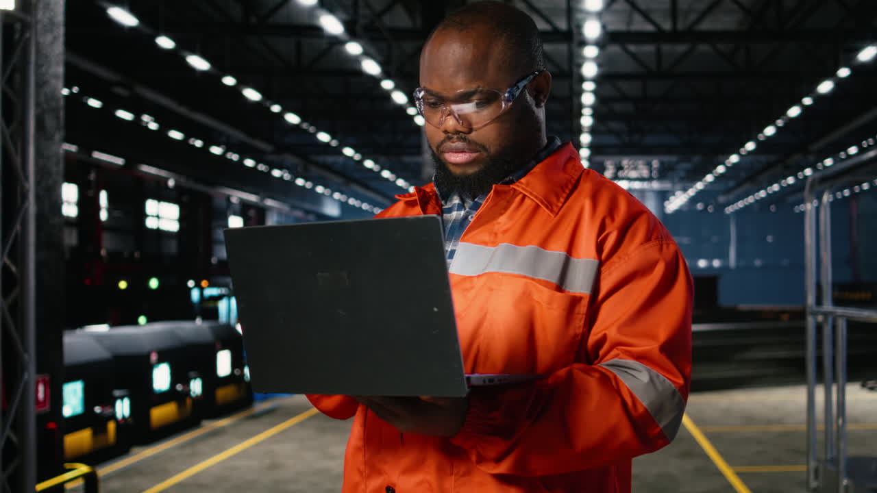 Factory personnel inspecting steel machinery in a warehouse plant