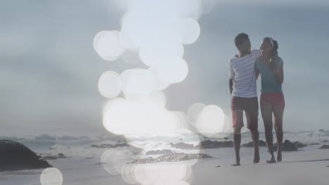 Animación-De-Puntos-Sobre-Una-Feliz-Pareja-Afroamericana-Caminando-Por-La-Playa